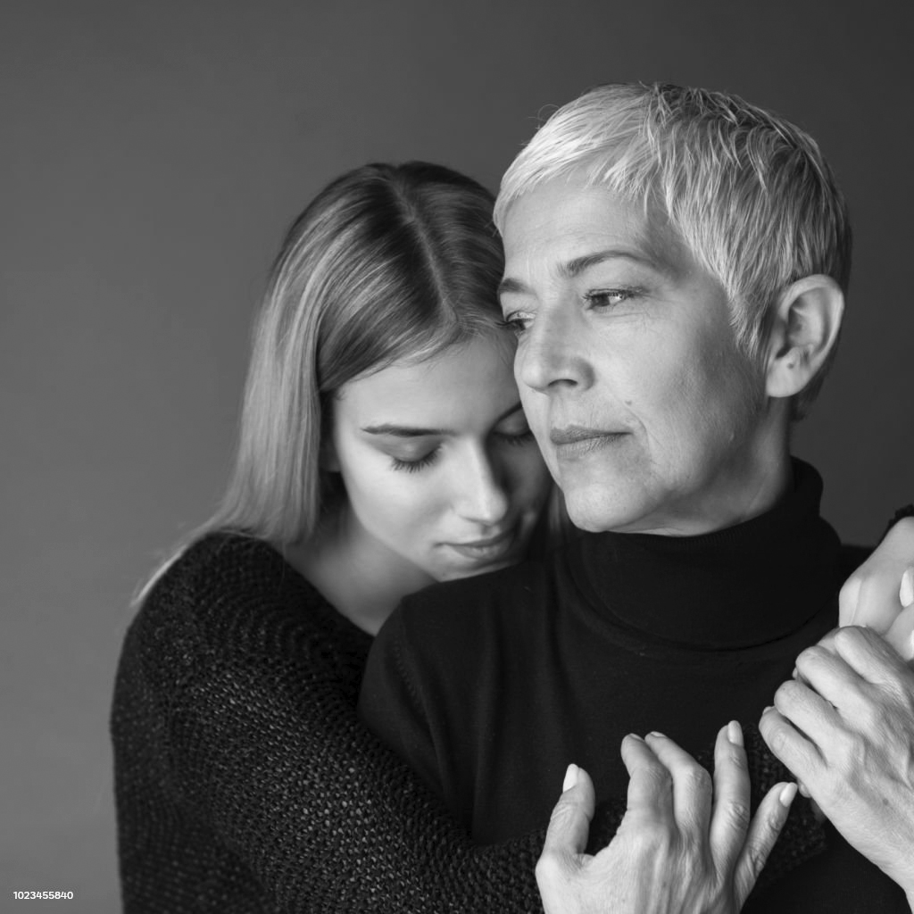 Studio shot of mother and daughter. Both of them wearing black.